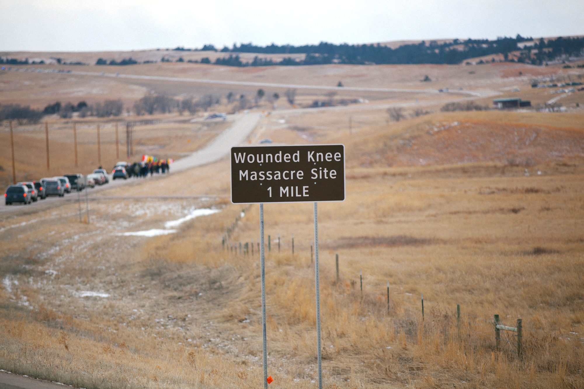 The road to the Wounded Knee Massacre Site, marchers small in the distance across the prairie